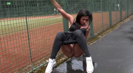 Dark haired girl put down jeans & panties to take a pee beside a tennis court 99069561
