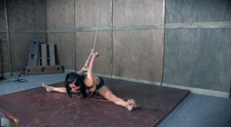 Tattooed female Lily Lane endures being tortured in a dungeon as best she can 12744673