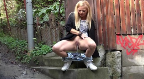 Blonde girl Jena Lovely pulls down ripped jeans for a pee in a laneway 23300766