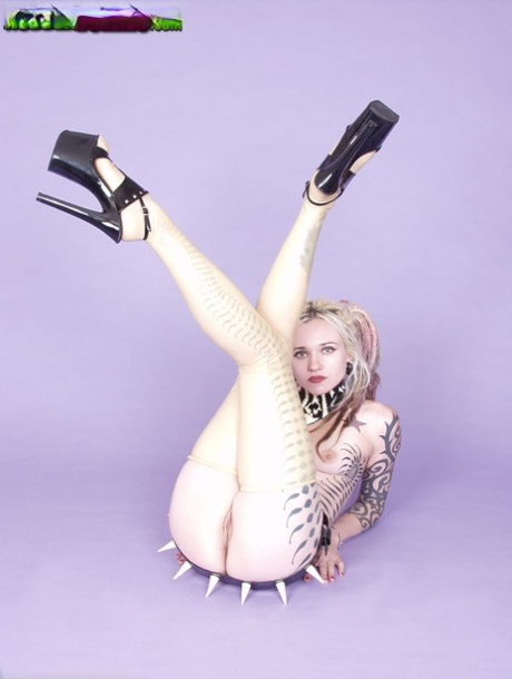 Tattooed blonde Voltaire Blue models naked in a spiky belt and heels 68894192