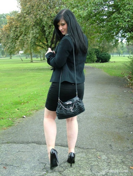 Fully clothed model Nicola takes a walk on park pathway in her new black pumps 85035903