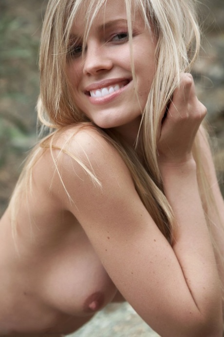 Smiling MILF Marketa shows off her nude body atop a rock outdoors 81267534