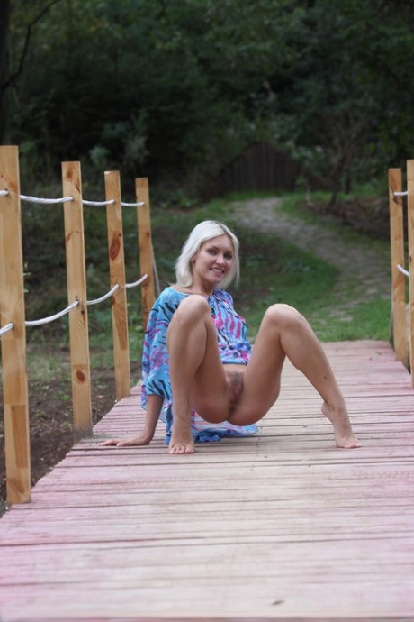 Blonde teen Kristy frees her private parts from a dress while on a dock 32263754