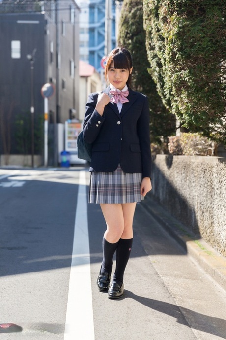 Japanese schoolgirl pulls down a cotton thong while on her bed 42607922