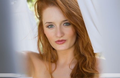 Sexy redhead Denisa touts her nice ass while hanging laundry in the nude 57599082