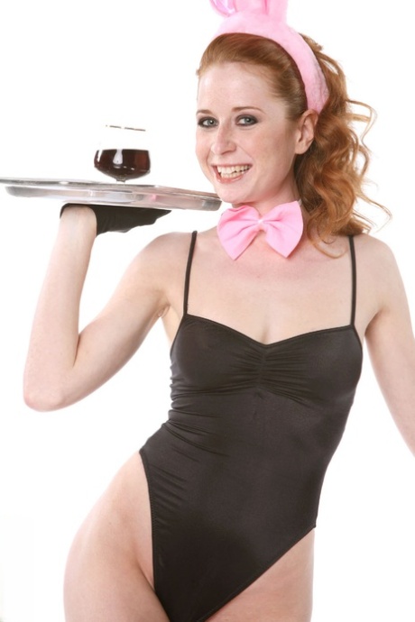 Natural redhead Lucie T holds a drink tray while stripping to fishnets 77628799