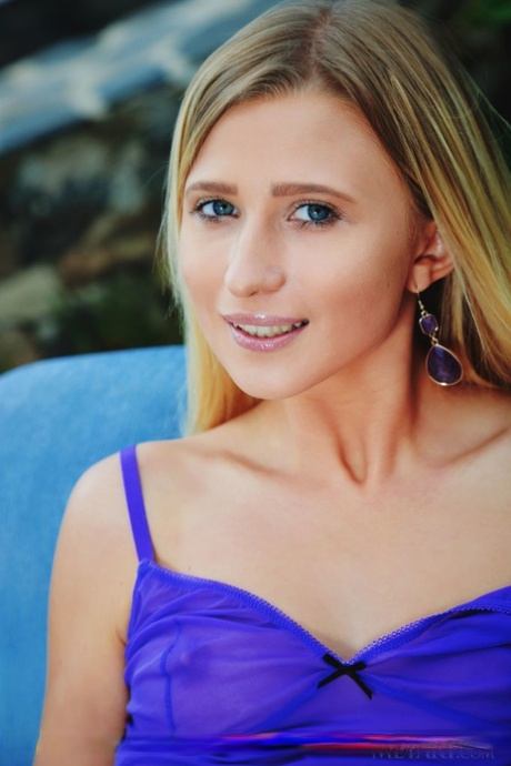 Blonde teen Lisa Dawn slips out of her clothing to go nude on an outdoor chair 31045575