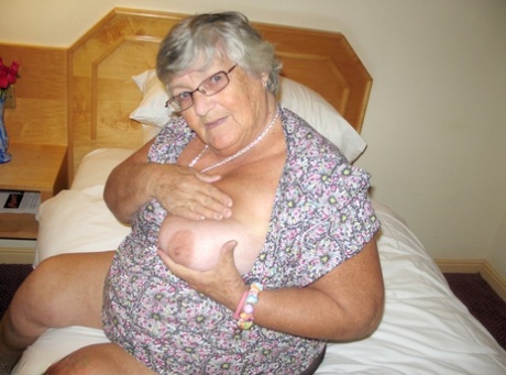 Silver haired British woman Grandma Libby exposes her fat body on a bed 77552892