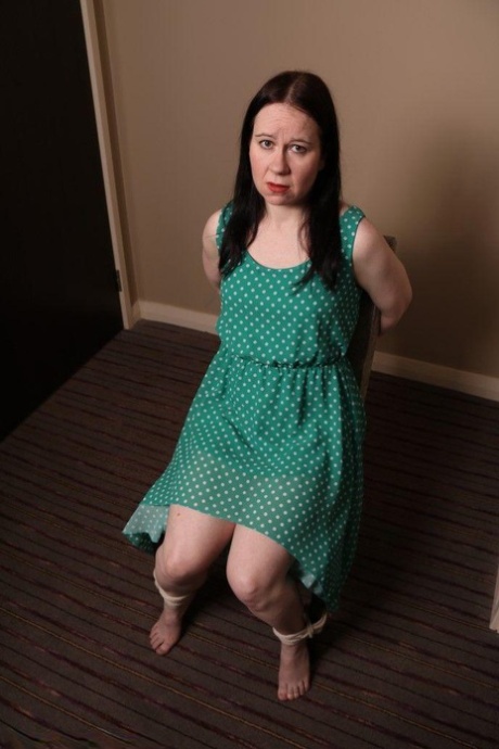 Distressed mature woman in polka-dot dress tied up & gagged for BDSM fun 14576344