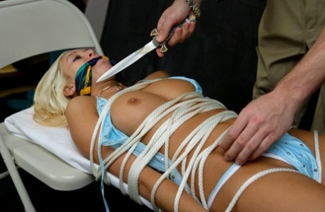 Tied up and cleave gagged blonde girl is threatened with a knife 74450842