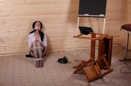 History teacher places herself into bondage prior to caning a female student 22408189