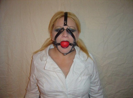 Blonde chick is silenced with a ball gag while showing her breasts 68159569