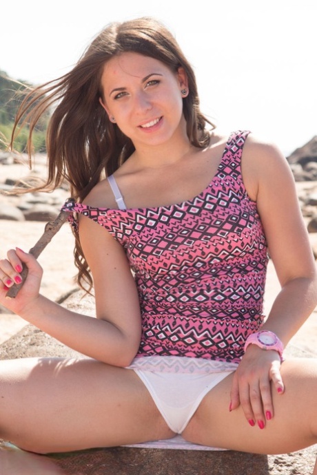 Teen amateur Ashley displays her pink pussy during close-up action on a beach 48372377