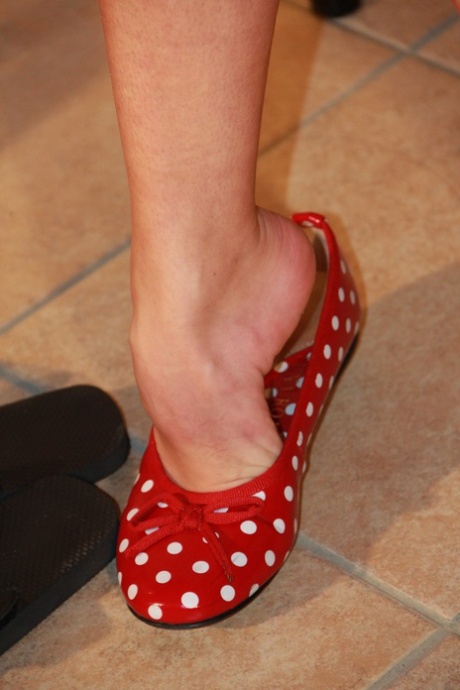 Clothed brunette Sunny flexes her toes before donning polka-dot flats 96047044