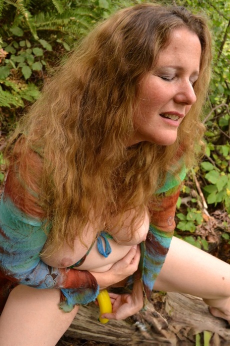 Busty amateur pleasures her horny pussy with a plastic banana in the woods 17372623