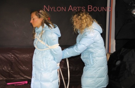 Caucasian chick gags and binds her girlfriend in a winter coat and nylon pants 38937042