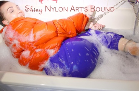 Pretty girl is left ball gagged and cuffed in winter clothing in a bathtub 75575069