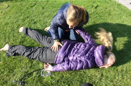 Blonde lesbian is tied up and soaked on a lawn in winter clothing 98617691