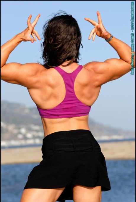 Brunette bodybuilder Lada Phihalova flexes on a beach while wearing sunglasses 65083718