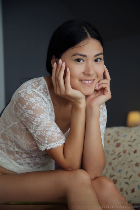 Asian teen Kimiko shows the bottoms of her bare feet during a nude session 75705712