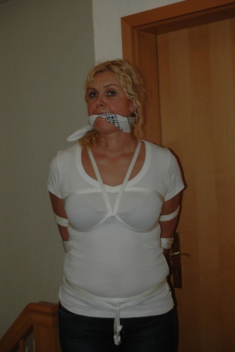Fully clothed blonde struggles against a cleave gag while tied up with rope 68764609