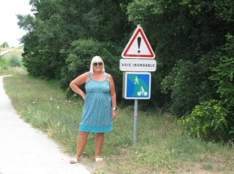 Older blonde BBW Chrissy Uk exposes her tits on a path through the woods 66415152