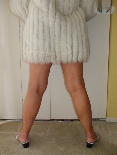 Mature amateur Busty Bliss exposes her tan lined tits while wearing a fur coat 18367047