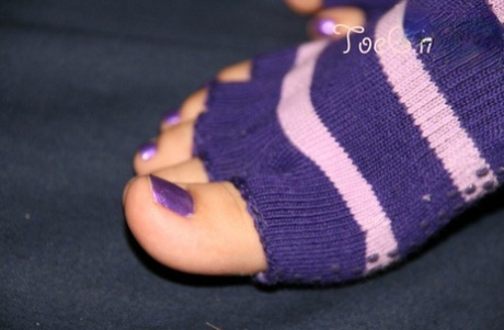 Caucasian female displays her painted toenails in toeless socks 21572870