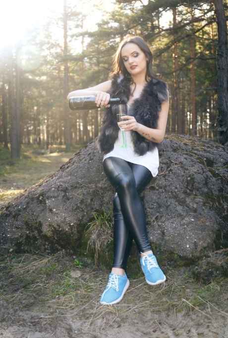 Beautiful teen Maria Z sticks an empty wine bottle in her pussy upon a boulder 34171839