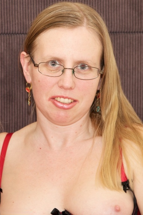 Mature lesbians have sexual relations on a bed in hosiery and glasses 58317056