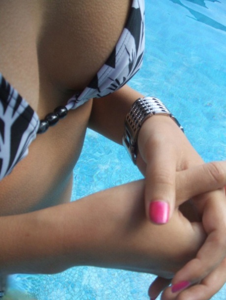 Amateur chick Roxy glances at her Morgan watch while in a swimming pool 31196995