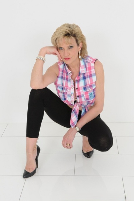 Mature blonde Lady Sonia displays her cleavage in black leggings and heels 21737548