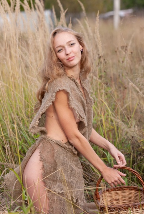 Barely legal girl Jessie U displays her naked figure in tall grasses 70477228