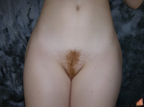 Young redhead Harper Red barely suppresses a smile while going nude 82346418