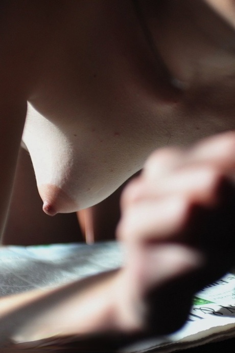 Solo girl Jessi Palmer peers over her glasses before showing her small tits 31570348