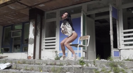 Brunette chick Gypsy Queen takes a piss on a chair outside a dilapidated motel 54876182