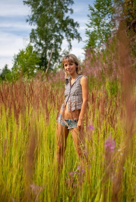 18-year-old blonde Nicole V gets totally naked against a sandy mound 20120858