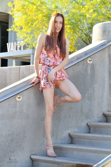 Solo girl with long hair masturbates with a banana in the shade on a patio 50055732