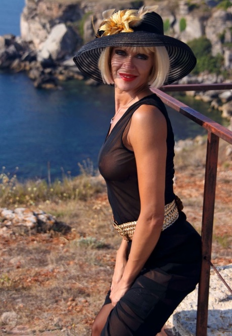 Classy blonde MILF Eva Diangelo shows her bare ass at a scenic location 77909868