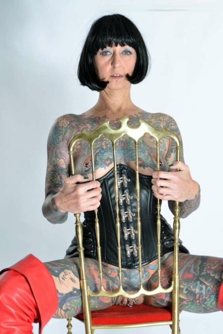 Solo girl Tattoogirl Cleo gets naked in a leather waist cincher and long boots 61732669