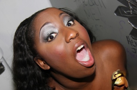 Busty black chick Luxury Amore sports a mouthful of cum at a gloryhole 66013432