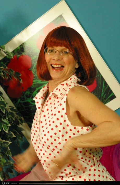 Older redhead Miss Abigail frees her boobs from half cup bra in nylons 87286479