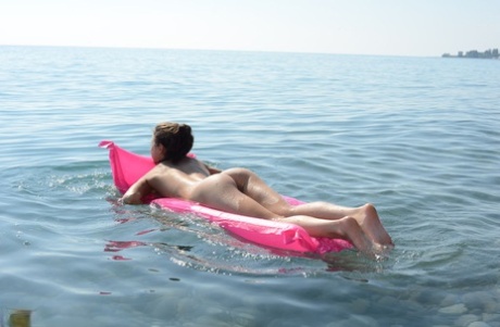 Teen solo girl models in the nude on a rocky beach at low tide 50993109