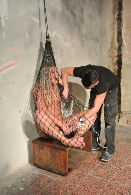 Nude chick is kept confined in a fish net while being masturbated 10473572