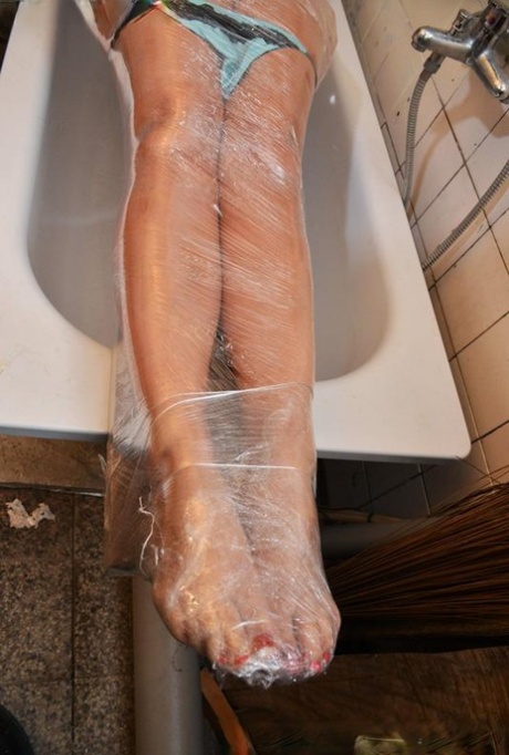 Busty blonde chick Vicky is wrapped in saran wrap and gagged atop bathtub 99374573