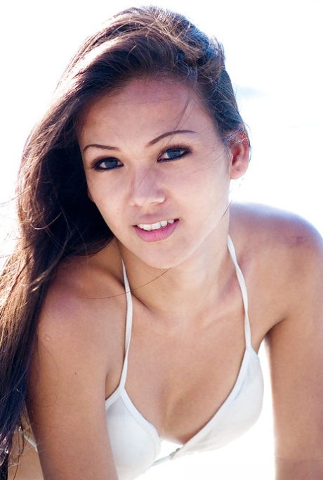 Beautiful ladyboy Amy poses in skimpy bikini on beach outdoors 74894549